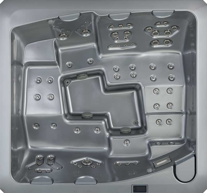 Vista dall'alto di una piscina idromassaggio USSPA di colore grigio con sedute ergonomiche e molteplici zone di getti.