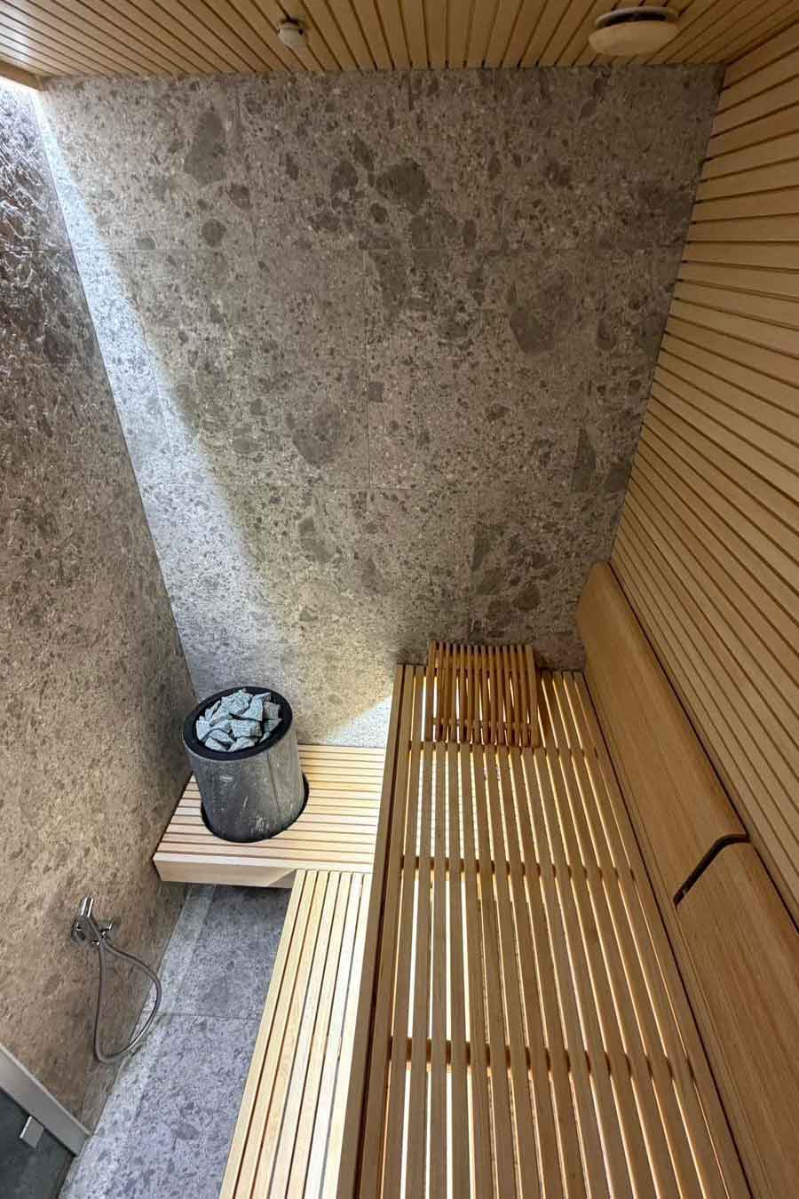 Sauna con finiture in legno e pietra